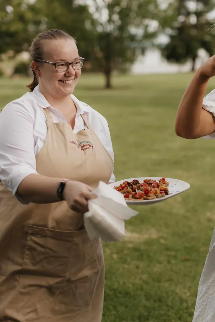 Jemma Archer from Archers Catering & Events serving canapés at an outdoor wedding in the Toowoomba region